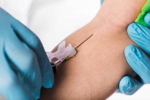 Eagle River Alaska phlebotomy tech taking blood sample from patient